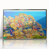 Framed acrylic wall art showcasing a picturesque village landscape with vibrant colors and intricate details, designed to enhance home decor aesthetics.