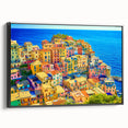Framed canvas wall art showcasing a scenic village landscape design, featuring vibrant colors and intricate details, displayed from a side view against a neutral backdrop.