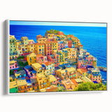 Framed canvas wall art showcasing a serene village landscape design with vibrant colors, presented in a sleek white frame, ideal for home decor.