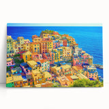 Stretched canvas wall art featuring a serene village landscape design with vibrant colors and detailed brushwork, leaning against a neutral wall, ideal for home decor.