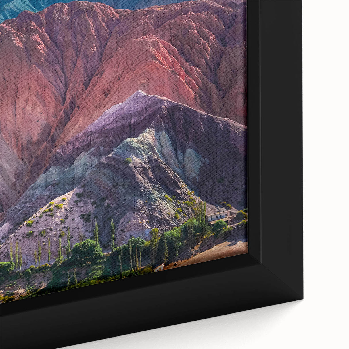 Close-up of a framed canvas wall art piece showcasing a vibrant village landscape design, featuring lush greenery and colorful homes, ideal for enhancing interior decor.