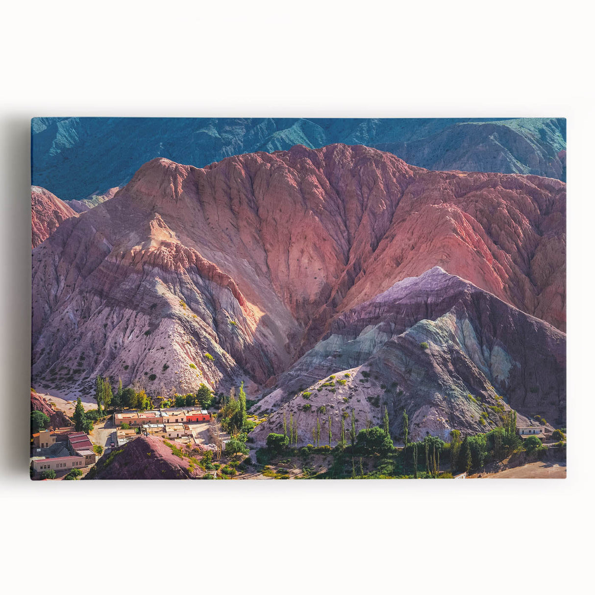 Vibrant stretched canvas wall art showcasing a serene village landscape, featuring lush greenery and a clear blue sky, perfect for home decor or art enthusiasts.