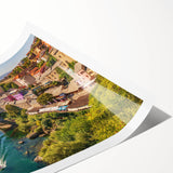 Rolled print of a serene landscape depicting a quaint village surrounded by lush greenery, showcasing vibrant colors and intricate details, ideal for home decor.