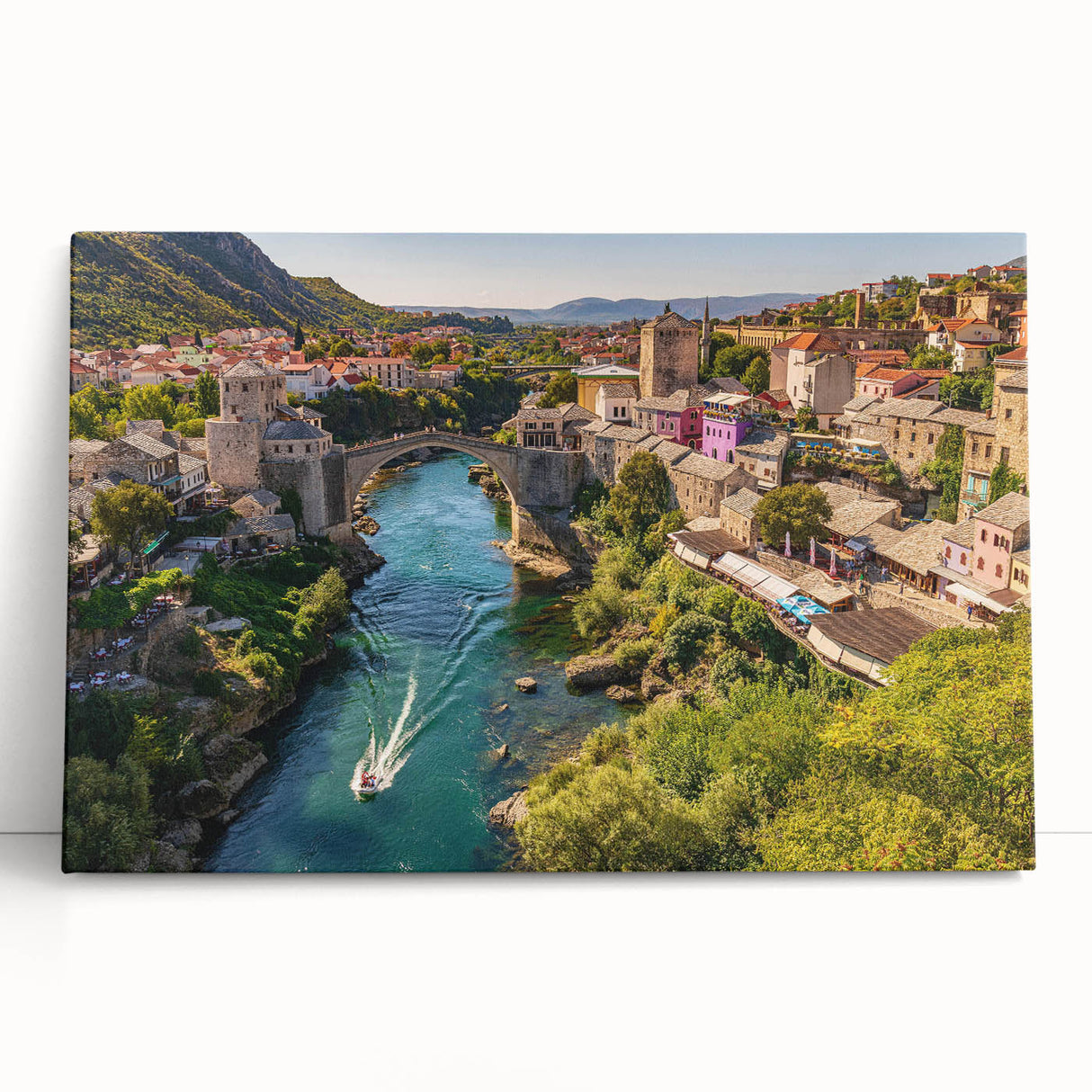 Stretched canvas wall art featuring a vibrant landscape design of a quaint village, showcasing lush greenery and serene skies, perfect for home decor.