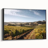 Framed canvas wall art featuring a scenic vineyard landscape with lush green grapevines, vibrant blue skies, and a black frame, perfect for enhancing home decor.