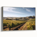 Framed canvas wall art showcasing a serene vineyard landscape with vibrant green hills and a clear blue sky, elegantly presented with a silver frame. Ideal for home decor.