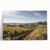 Vibrant stretched canvas artwork depicting a picturesque vineyard landscape, showcasing lush green vines and rolling hills under a blue sky, perfect for home decor.
