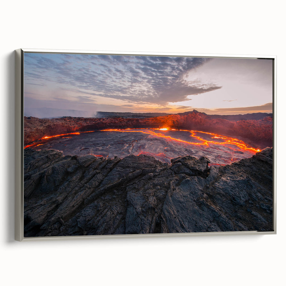 Framed canvas wall art depicting a vibrant volcano landscape with lush greenery and dramatic skies, set in a sleek silver frame, perfect for modern decor.