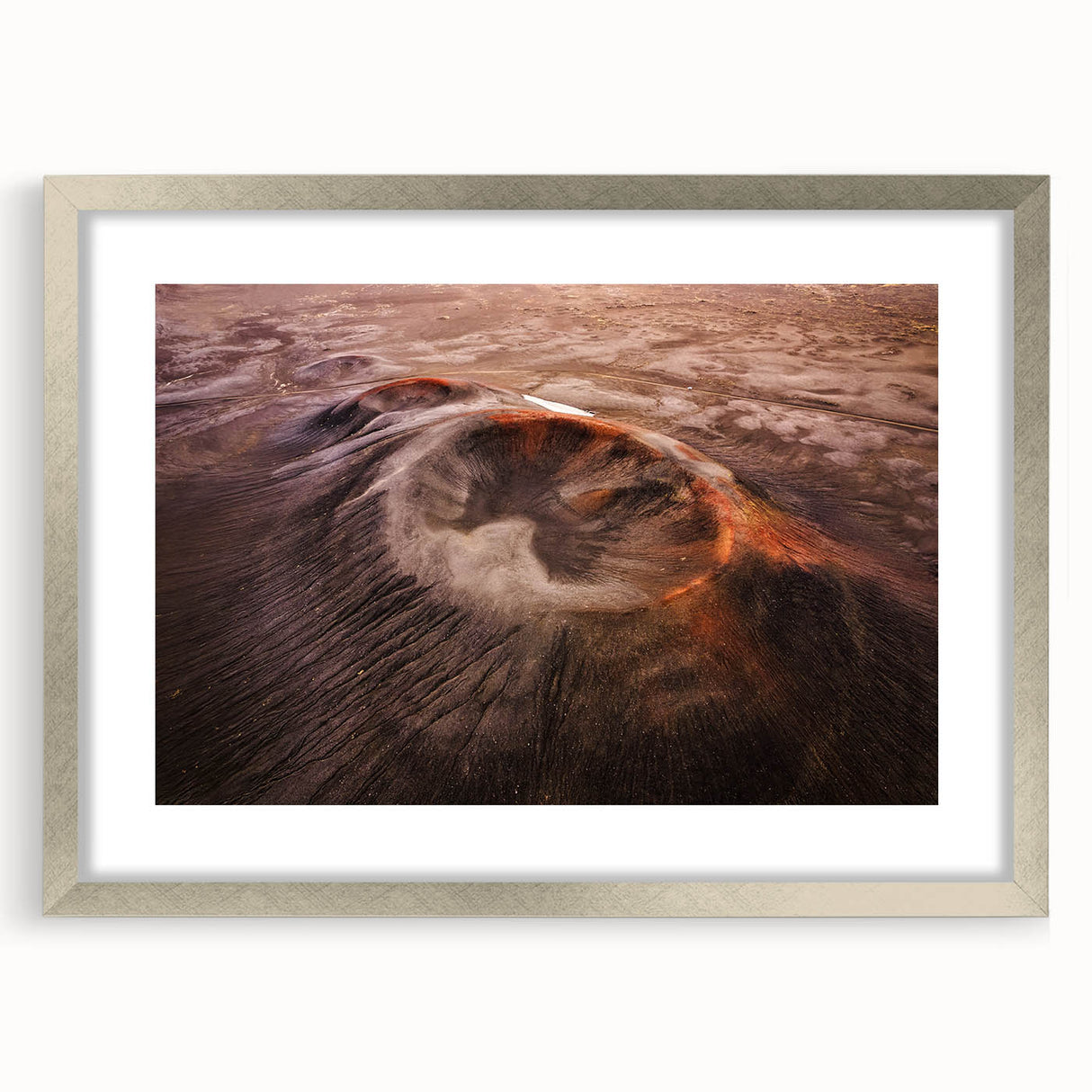 Framed landscape wall art featuring a vibrant volcanic scene, highlighted in a sleek silver frame with a mat. Ideal for modern home decor and art enthusiasts.