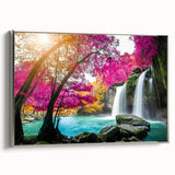 Framed canvas wall art showcasing a serene waterfall landscape, featuring vibrant greens and blues, elegantly displayed with a silver frame for a modern touch.