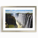 Framed wall art featuring a serene waterfall landscape design, set in a sleek silver frame with a white mat, perfect for home decor. This high-quality piece enhances any room's ambiance with its tranquil imagery.
