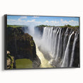 Framed canvas wall art depicting a serene waterfall landscape, showcasing vibrant blues and greens, with a sleek black frame enhancing its modern aesthetic. Ideal for nature lovers and home decor enthusiasts.