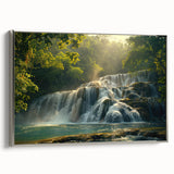 Framed canvas wall art showcasing a serene waterfall landscape with vibrant hues of blue and green, accented by a sleek silver frame, perfect for home decor.