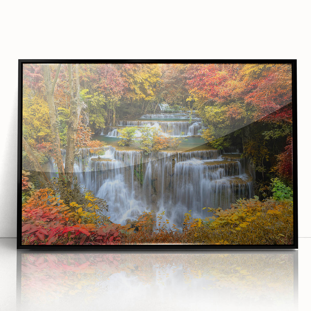 Framed acrylic wall art showcasing a serene waterfall landscape, featuring vibrant blues and greens, perfect for home decor or office ambiance.