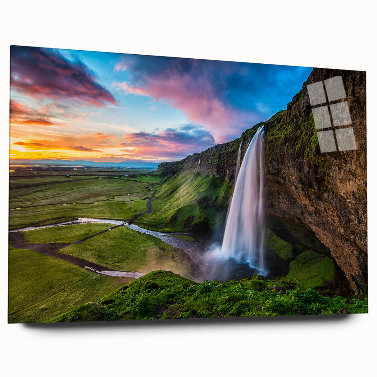 Acrylic glass artwork showcasing a stunning waterfall landscape, featuring vibrant blue and green hues. The piece is elegantly displayed from a side view, highlighting its sleek design without pins, ideal for modern home decor.