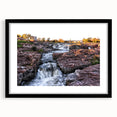 Framed black wall art featuring a serene landscape of cascading waterfalls, set against lush greenery, ideal for enhancing any modern home decor.
