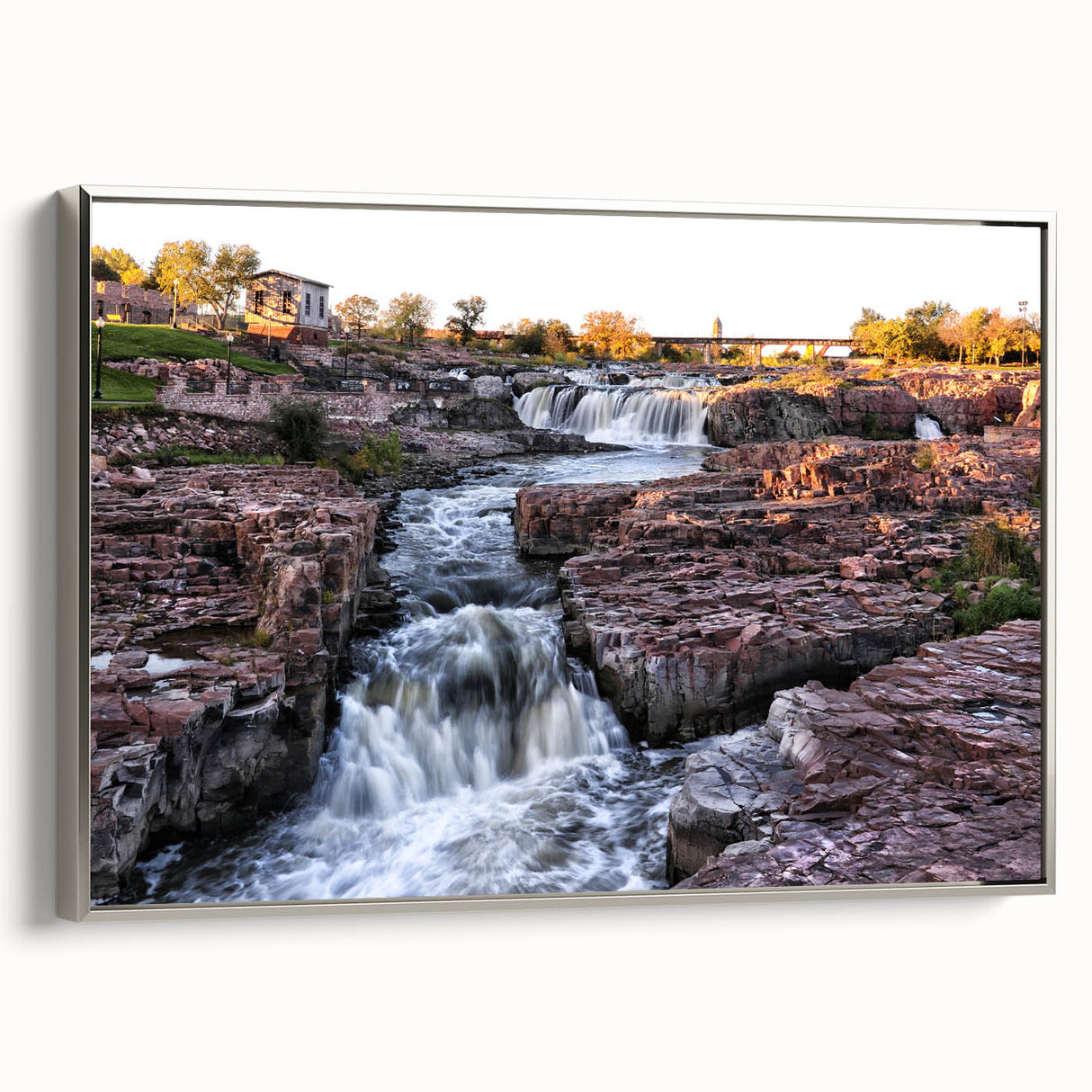 Framed canvas wall art showcasing a stunning waterfall landscape with vibrant colors, silver accents, and a sleek side view, perfect for home decor.