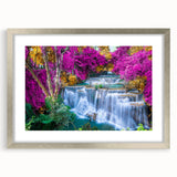 Framed landscape wall art featuring a serene waterfall design with vibrant greens and blues, accented by a sleek silver mat, ideal for home decor.