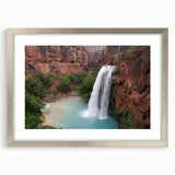 Framed wall art featuring a serene waterfall landscape in vibrant colors, surrounded by a silver mat and frame, perfect for home decor and nature enthusiasts.