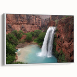 Framed canvas wall art showcasing a serene waterfall landscape, featuring vibrant blues and greens, elegantly displayed with a white frame, perfect for home decor.