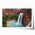 Stunning landscape wall art print featuring a serene waterfall cascading over rocks, surrounded by lush greenery, perfect for home decor and nature enthusiasts.