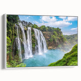 Framed canvas wall art showcasing a serene waterfall landscape, featuring vibrant blues and greens, designed to enhance home decor with a tranquil ambiance.