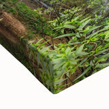 Close-up of a vibrant, stretched canvas featuring a serene waterfall landscape design with lush greenery and detailed textures, perfect for home decor.