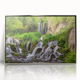 Framed acrylic wall art featuring a stunning landscape of a waterfall, with vibrant colors and intricate details. The silver frame complements the serene scene, perfect for home decor. Ideal for nature enthusiasts seeking to enhance their interior with captivating art.