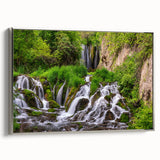 Framed canvas wall art showcasing a serene waterfall landscape design with silver accents, perfect for enhancing modern home decor. The artwork captures vibrant colors and natural beauty, providing a calming focal point for any room.