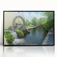 Framed acrylic wall art featuring a serene watermill landscape design with lush greenery and soft blue skies, presented in a sleek black frame for modern decor.