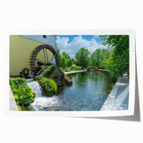 Rolled print of a serene landscape featuring a traditional watermill surrounded by lush greenery, ideal for home decor, showcasing natural beauty and tranquility.