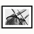 Framed wall art featuring a serene landscape with windmills, showcased in a sleek black frame with matting, perfect for enhancing modern home decor.