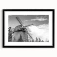 Black-framed wall art featuring a picturesque landscape with windmills, showcasing vibrant colors and intricate details, perfect for enhancing home decor.