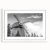 Framed landscape wall art featuring windmills against a serene sky, displayed in a white mat and frame, perfect for modern home decor and interior design.