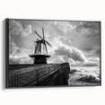 Framed canvas wall art showcasing a picturesque landscape with windmills against a vibrant sunset, featuring a sleek black frame and side view display, ideal for home decor.
