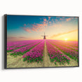 Framed canvas wall art featuring a serene landscape with windmills, showcasing a vibrant sunset scene. The artwork is presented in a sleek black frame, adding a modern touch to home decor. Ideal for enhancing living spaces with its calming colors and natural elements.