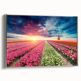 Framed canvas wall art showcasing a serene landscape with windmills, highlighted by a silver frame, perfect for modern home decor accents. The artwork captures a tranquil scene, ideal for enhancing living spaces or offices.