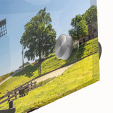 Close-up of a vibrant landscape wall art print showcasing windmills against a colorful sunset, framed in acrylic glass to enhance its visual appeal. Ideal for home decor.