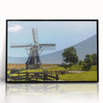 Framed acrylic wall art showcasing a landscape with windmills, featuring a sleek black frame and vibrant colors, perfect for home decor enhancement.