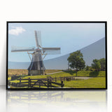 Framed acrylic wall art showcasing a landscape with windmills, featuring a sleek black frame and vibrant colors, perfect for home decor enhancement.