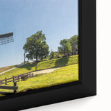 Framed canvas wall art showcasing a vibrant landscape with windmills against a colorful sunset, perfect for adding a rustic touch to home decor.