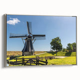 Framed canvas wall art showcasing a serene landscape with windmills under a vibrant sunset, featuring a silver frame that enhances its aesthetic appeal.