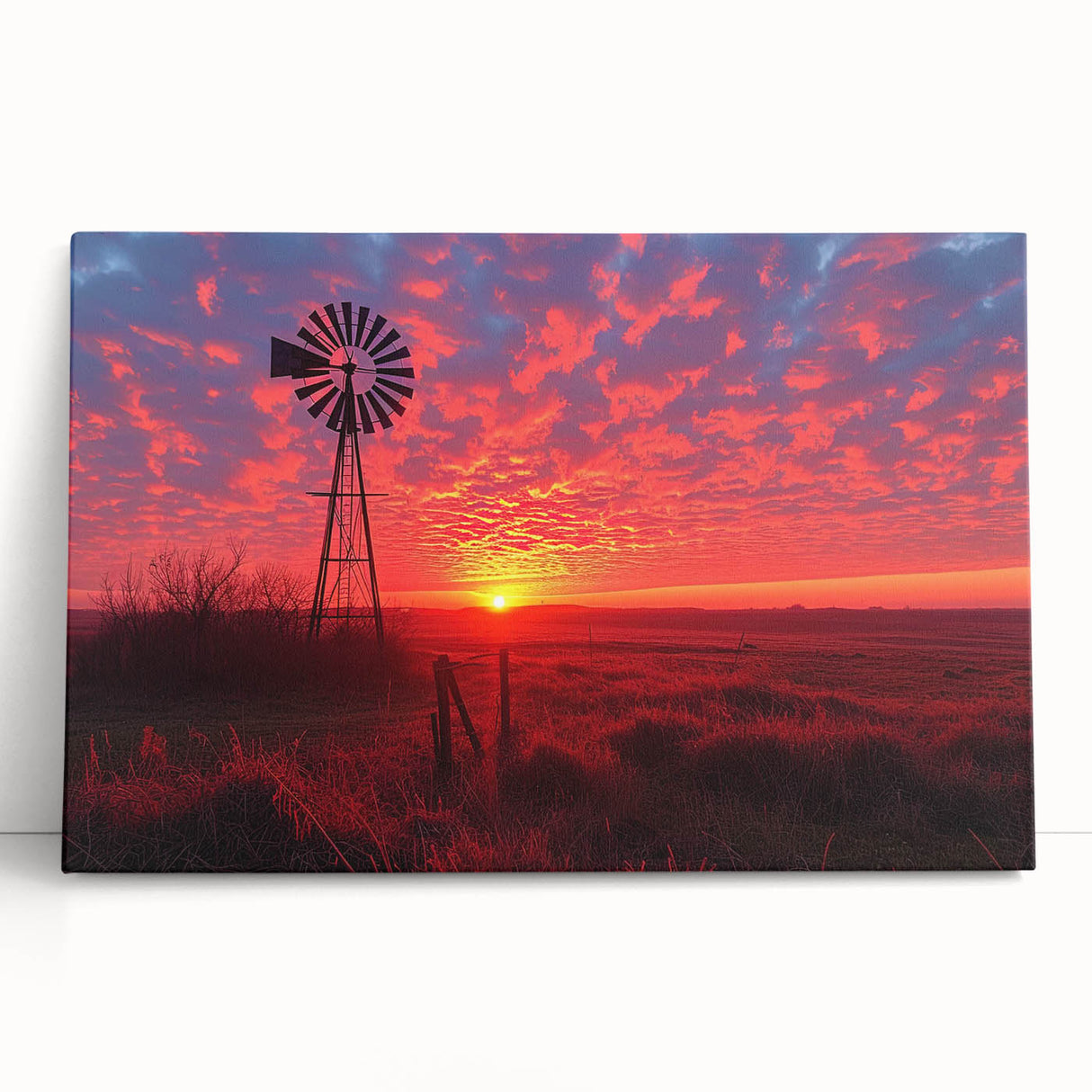 Stretched canvas artwork depicting a serene landscape with windmills under a vibrant sunset, perfect for adding a rustic touch to home decor.