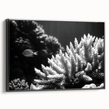 Framed canvas wall art showcasing a vibrant marine life coral design, featuring intricate details in shades of blue and orange against a sleek black frame, ideal for ocean-themed decor.