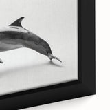 Close-up of a framed canvas wall art featuring a vibrant dolphin design surrounded by marine life, showcasing rich colors and intricate details perfect for ocean-themed decor.