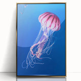 Framed wall art featuring a stunning jellyfish design in vibrant blues and greens, set in a sleek gold frame, perfect for marine life enthusiasts. Ideal for coastal decor.