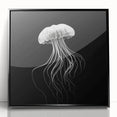 Framed wall art featuring a vibrant jellyfish design in shades of blue and pink, set against a sleek black frame, ideal for marine-themed home decor.