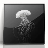 Framed wall art featuring a vibrant jellyfish design in shades of blue and pink, set against a sleek black frame, ideal for marine-themed home decor.