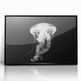 Framed wall art showcasing a vibrant jellyfish design in shades of blue and purple, set in a sleek black frame, perfect for marine-themed decor.