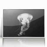 Framed wall art featuring a vibrant jellyfish design in shades of blue and purple, showcasing marine life with a sleek white frame, perfect for ocean-themed decor.
